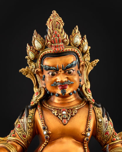 Yellow Dzambhala statue upper body close-up showing crown and jewelry
