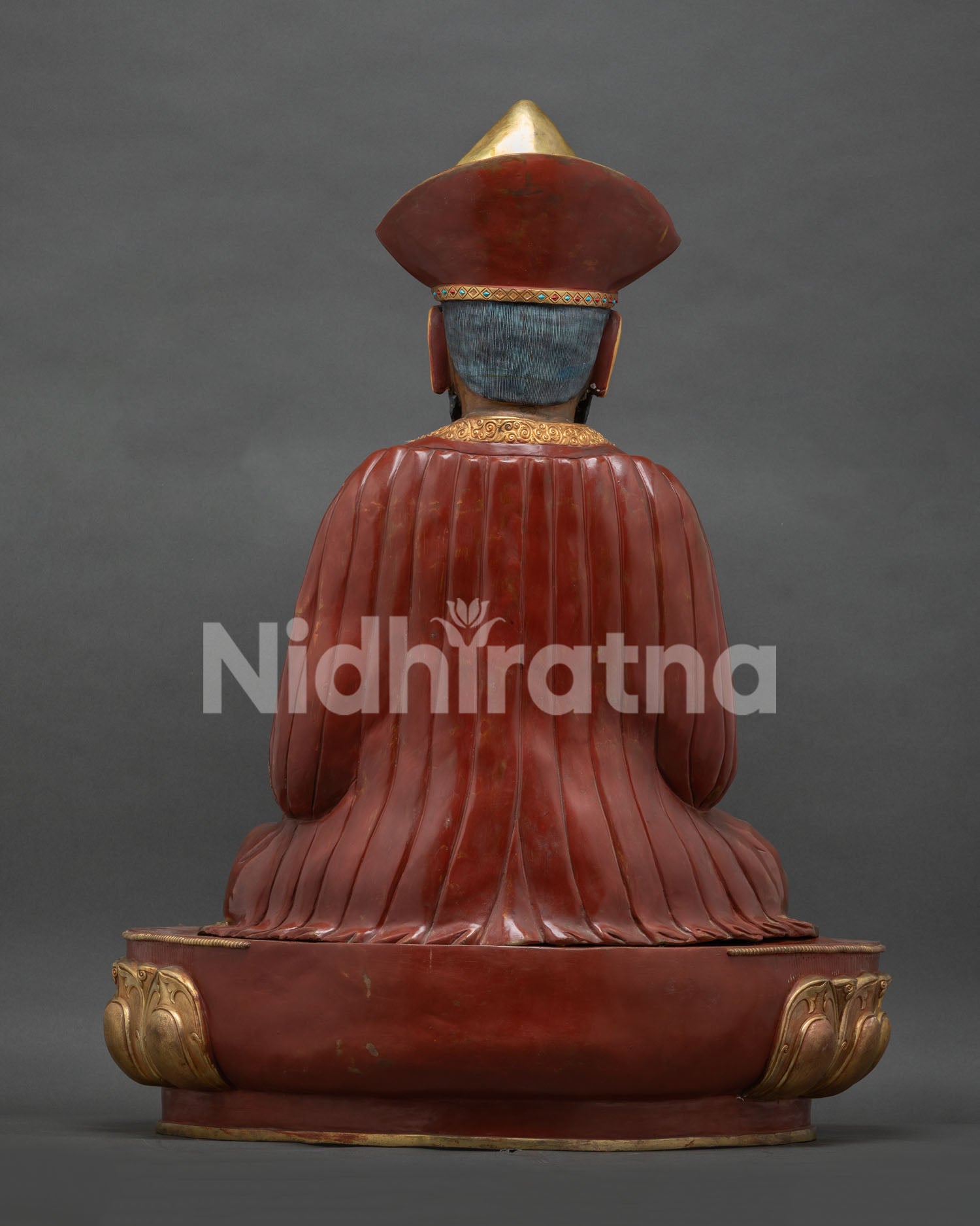 Zhabdrung Rinpoche statue back view, red robe detail, gold fire-gilded copper